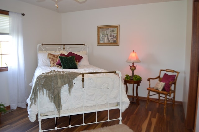 bedroom featuring ceiling fan and dark hardwood / wood-style flooring