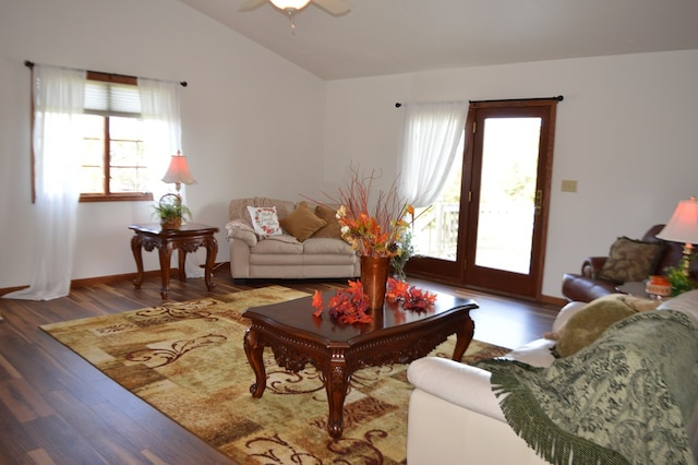 living room featuring dark hardwood / wood-style floors, ceiling fan, and vaulted ceiling