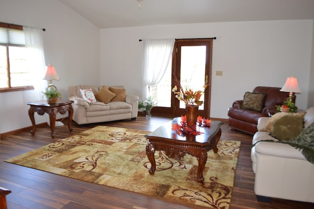 living room with dark hardwood / wood-style flooring and lofted ceiling