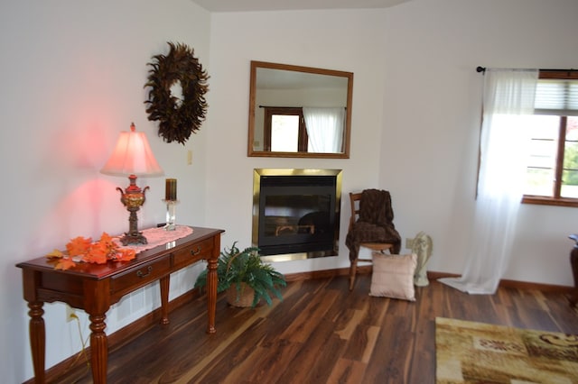 sitting room with a healthy amount of sunlight and dark hardwood / wood-style flooring