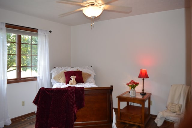 bedroom with ceiling fan and dark hardwood / wood-style floors