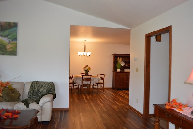 interior space featuring a notable chandelier, dark hardwood / wood-style floors, and lofted ceiling