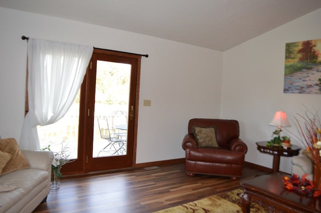 living room with vaulted ceiling and dark wood-type flooring