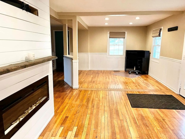 114 Avalon Rd, Mount Vernon, OH 43050 - unfurnished living room with light wood-style floors, wainscoting, and an office area