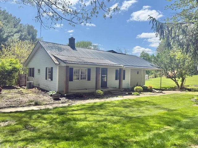 114 Avalon Rd, Mount Vernon, OH 43050 - view of front of house with cooling unit, a front lawn, metal roof, and a chimney