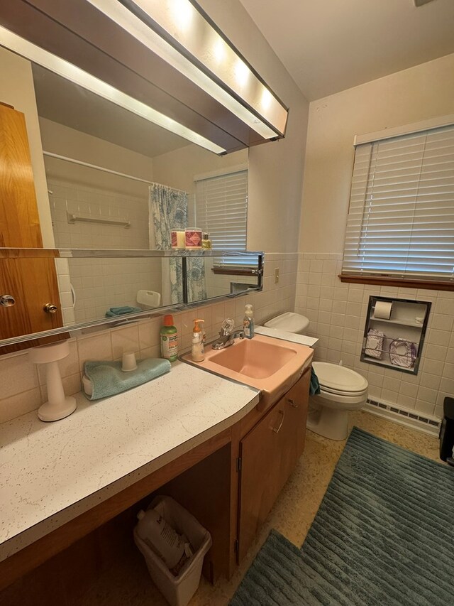 763 Sunnyside Dr, Galion, OH 44833 - bathroom featuring tile walls, vanity, a shower with shower curtain, and a wainscoted wall