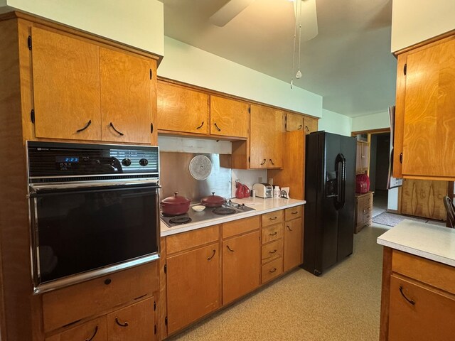 763 Sunnyside Dr, Galion, OH 44833 - kitchen with black appliances, light countertops, brown cabinetry, ceiling fan, and under cabinet range hood