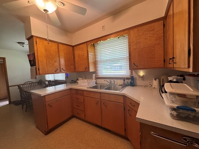 763 Sunnyside Dr, Galion, OH 44833 - kitchen featuring light countertops, a peninsula, a ceiling fan, and brown cabinets