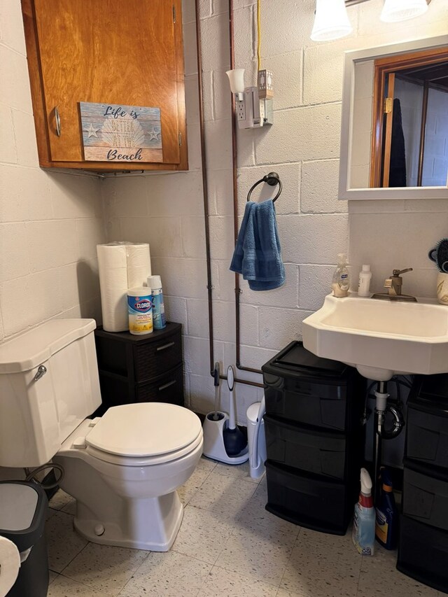 763 Sunnyside Dr, Galion, OH 44833 - half bath featuring concrete block wall and tile patterned floors