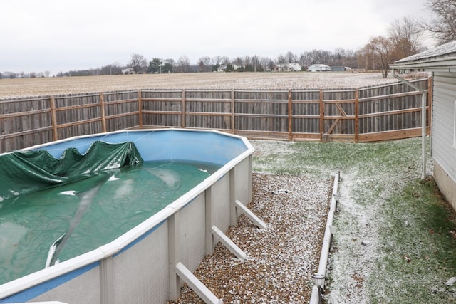 view of swimming pool featuring a rural view