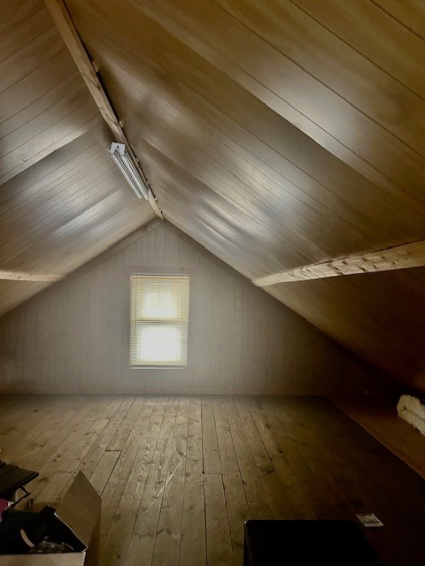 bonus room featuring lofted ceiling and hardwood / wood-style floors
