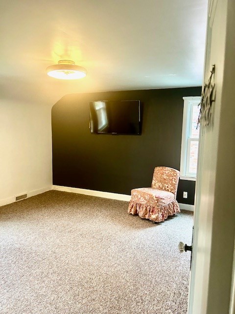 carpeted bedroom featuring baseboards and visible vents