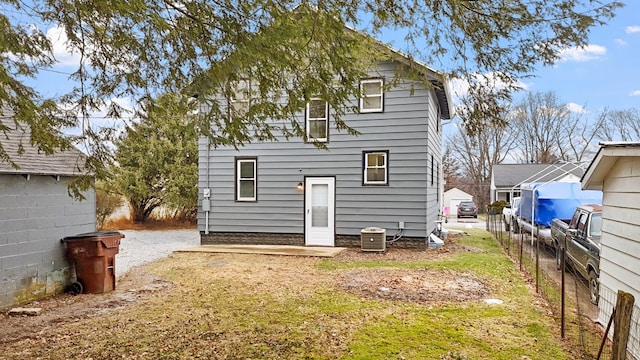 rear view of house with central AC unit