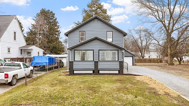 view of front of home with a garage and a front lawn