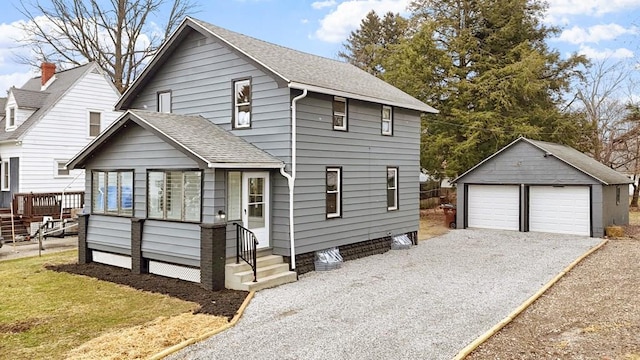 view of front of house with a garage and an outdoor structure