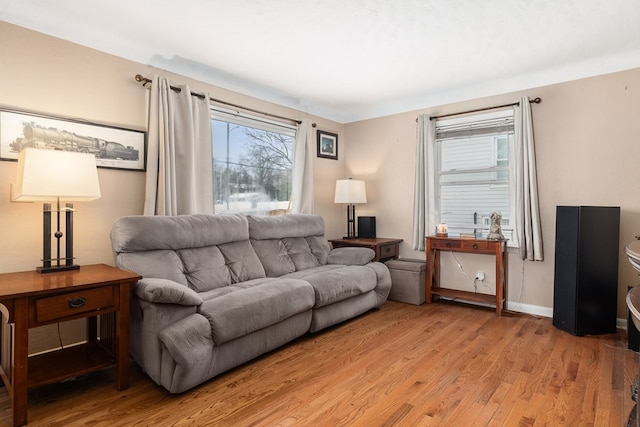 living room with a healthy amount of sunlight and light hardwood / wood-style floors