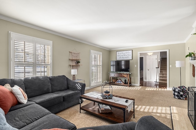 living room with light colored carpet, ornamental molding, and a healthy amount of sunlight