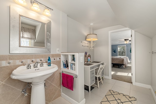 bathroom featuring tile walls, tile patterned floors, and lofted ceiling