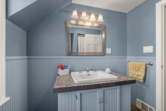 bathroom featuring vanity and vaulted ceiling