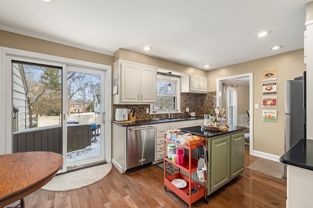 kitchen featuring appliances with stainless steel finishes, hardwood / wood-style floors, white cabinetry, sink, and green cabinets