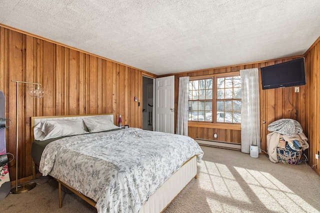 bedroom featuring light colored carpet, wood walls, a textured ceiling, and baseboard heating