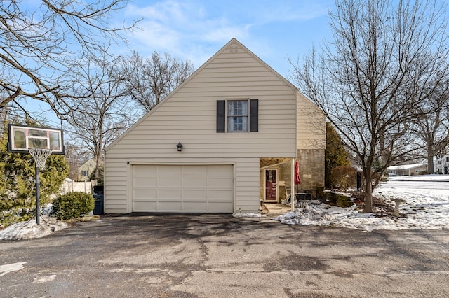 view of snow covered exterior featuring a garage