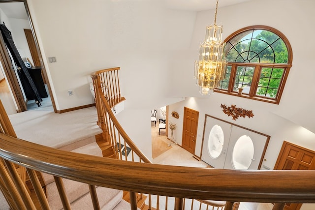 1515 Oak Run Ct, Mansfield, OH 44906 - staircase featuring a chandelier, a high ceiling, carpet flooring, and baseboards