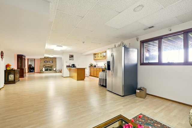 1515 Oak Run Ct, Mansfield, OH 44906 - kitchen with stainless steel refrigerator with ice dispenser, open floor plan, light wood-type flooring, glass insert cabinets, and light countertops
