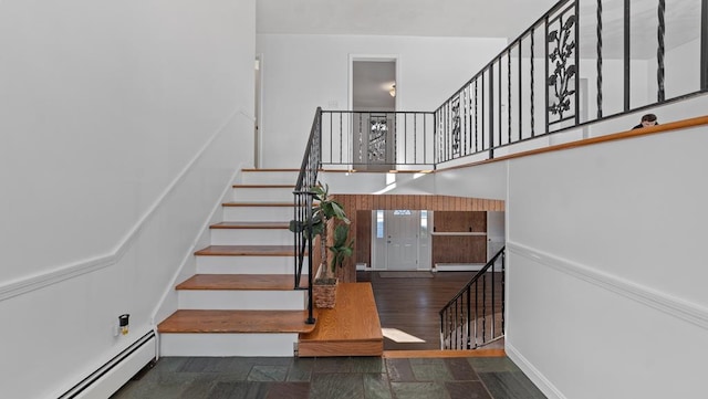 stairway featuring hardwood / wood-style floors and a baseboard radiator