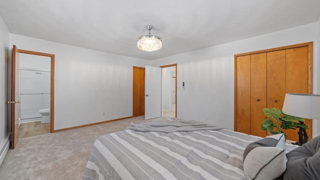 carpeted bedroom featuring baseboard heating and ensuite bath