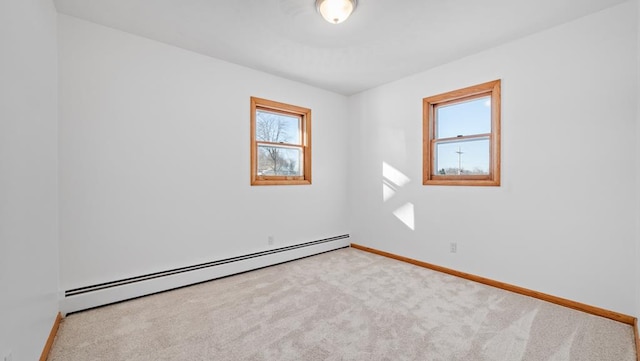 carpeted spare room with baseboard heating