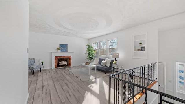 interior space featuring a fireplace, built in shelves, and wood-type flooring