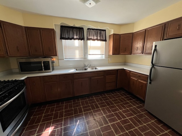 kitchen featuring sink, dark brown cabinetry, and stainless steel appliances