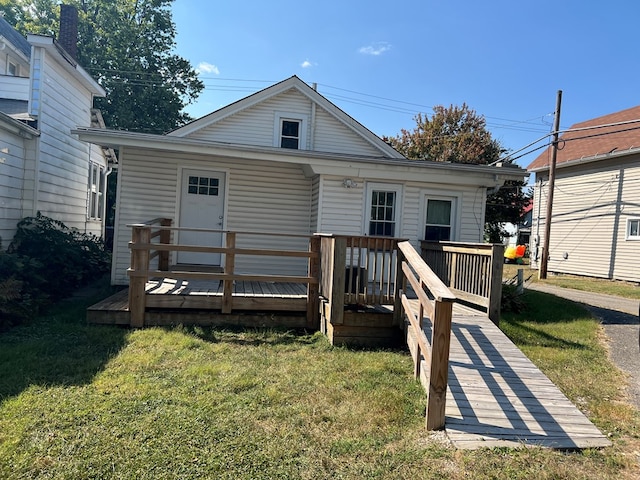 back of property featuring a yard and a deck