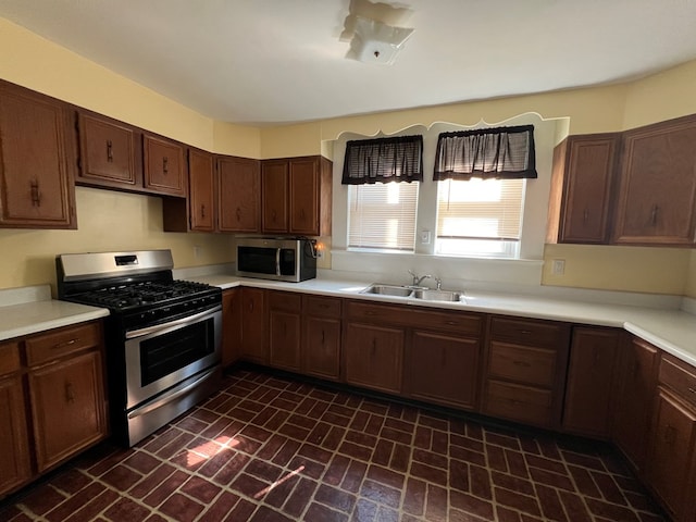 kitchen featuring sink, dark brown cabinets, and appliances with stainless steel finishes