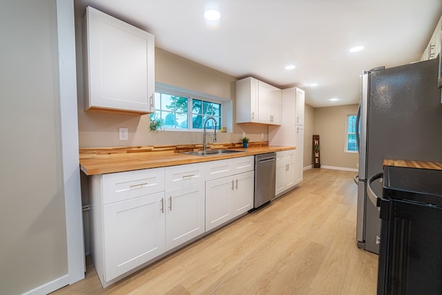 7331 State Route 314, Bellville, OH 44813 - kitchen featuring dishwasher, stove, wooden counters, light wood-style floors, and recessed lighting