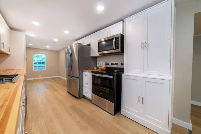 7331 State Route 314, Bellville, OH 44813 - kitchen with wood counters, stainless steel appliances, light wood finished floors, white cabinetry, and recessed lighting