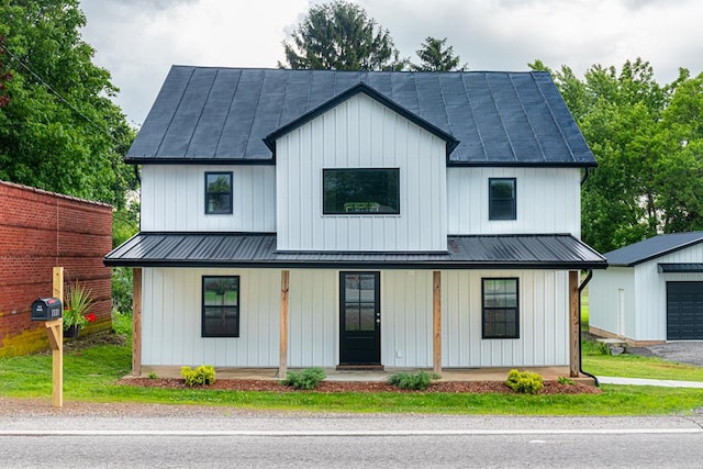 7331 State Route 314, Bellville, OH 44813 - modern farmhouse with covered porch, a metal roof, an outdoor structure, and board and batten siding