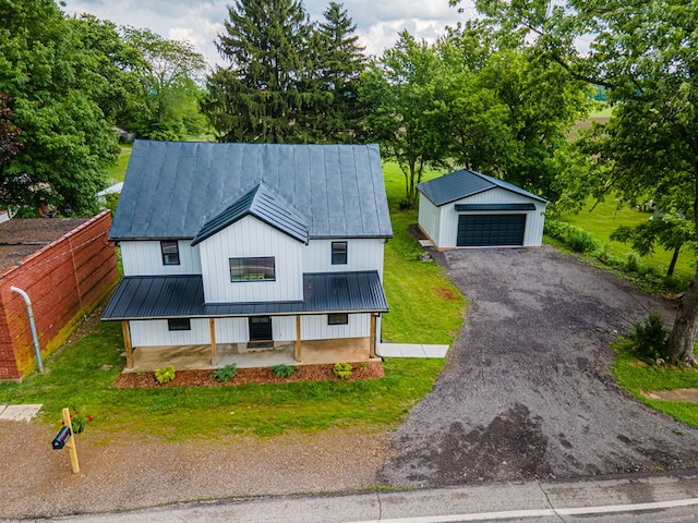 7331 State Route 314, Bellville, OH 44813 - modern farmhouse featuring a detached garage, a metal roof, an outbuilding, a standing seam roof, and view of scattered trees