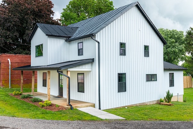 7331 State Route 314, Bellville, OH 44813 - view of front of home featuring a metal roof, a standing seam roof, a front lawn, a porch, and board and batten siding