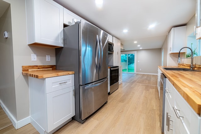 7331 State Route 314, Bellville, OH 44813 - kitchen with wooden counters, appliances with stainless steel finishes, light wood-style floors, and recessed lighting