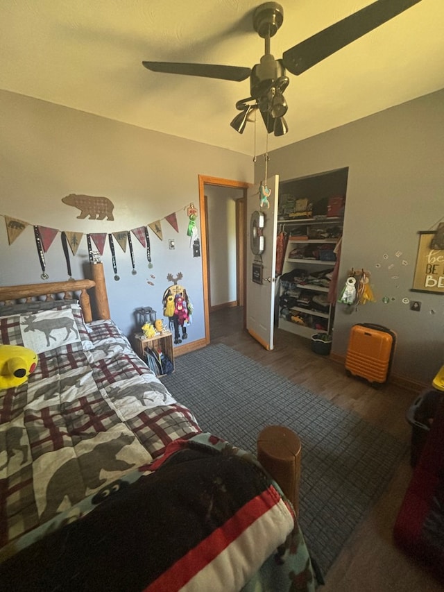 bedroom featuring hardwood / wood-style floors, a closet, and ceiling fan