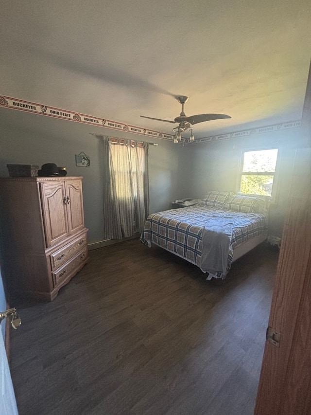 bedroom featuring ceiling fan and dark wood-type flooring