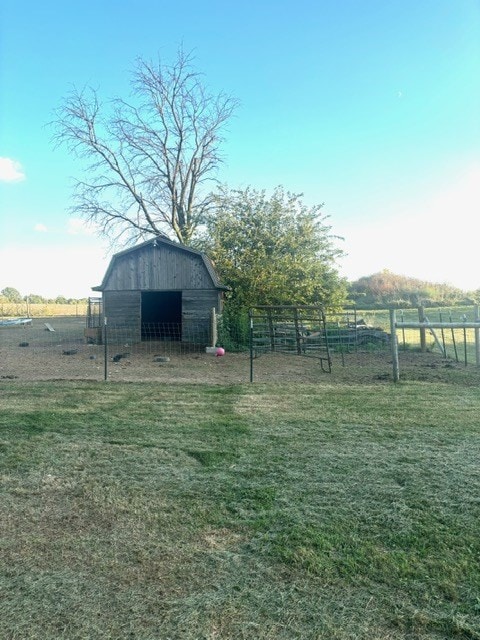 view of yard featuring a rural view and an outdoor structure