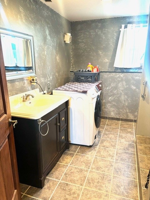 laundry area featuring washer / clothes dryer, sink, light tile patterned floors, and cabinets