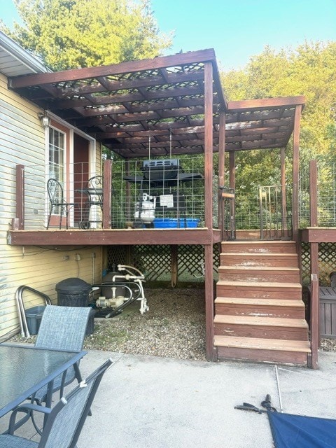 wooden terrace featuring a patio area and a pergola