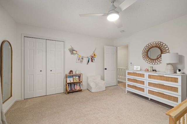 carpeted bedroom featuring ceiling fan and a closet