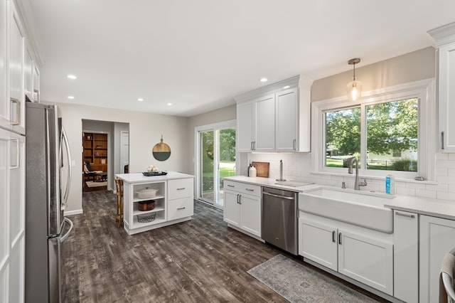 kitchen featuring white cabinets, pendant lighting, stainless steel appliances, and tasteful backsplash