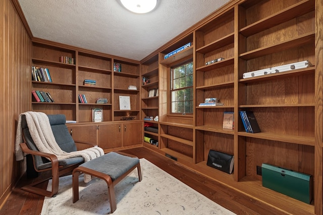 sitting room with hardwood / wood-style floors and a textured ceiling