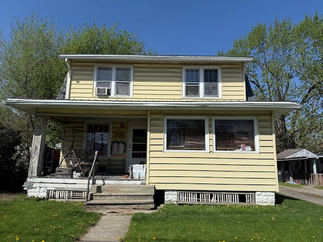 view of front facade featuring a porch and a front lawn